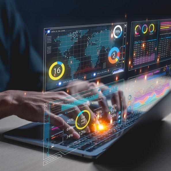 A businessman uses a laptop to access an AI-powered business analytics dashboard