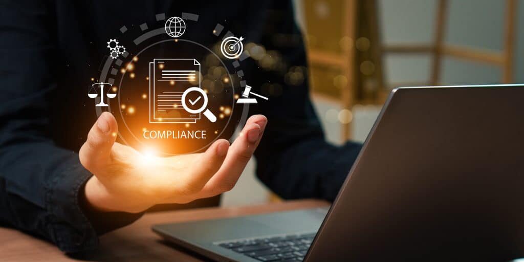 Businessman use laptop with compliance icon on virtual screen.