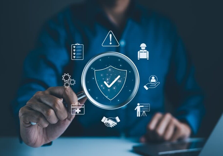 Work,Safety,And,Compliance,Concept.,Businessman,Holding,Magnifying,Glass,With Work Safety and Compliance
