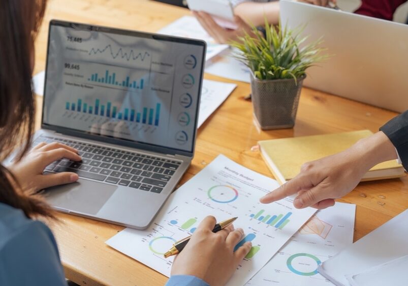 accountant with laptop and paperwork analyzing financial data report