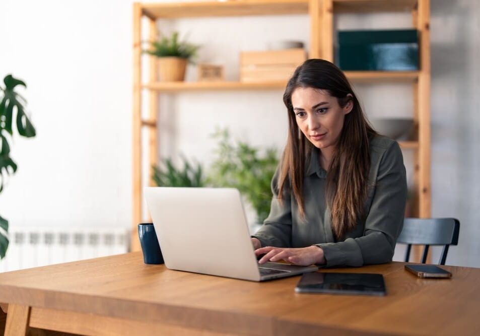 woman using laptop computer working from home office
