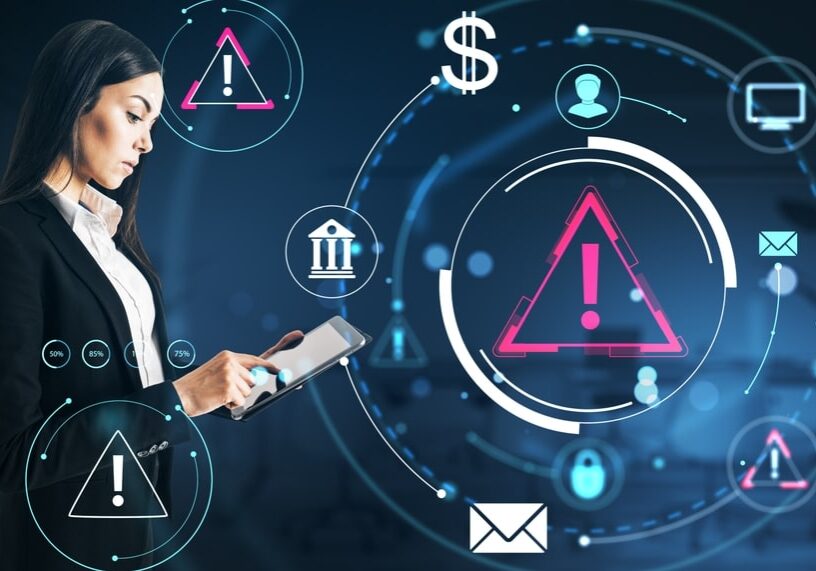 Businesswoman using tablet with warning icons and financial symbols