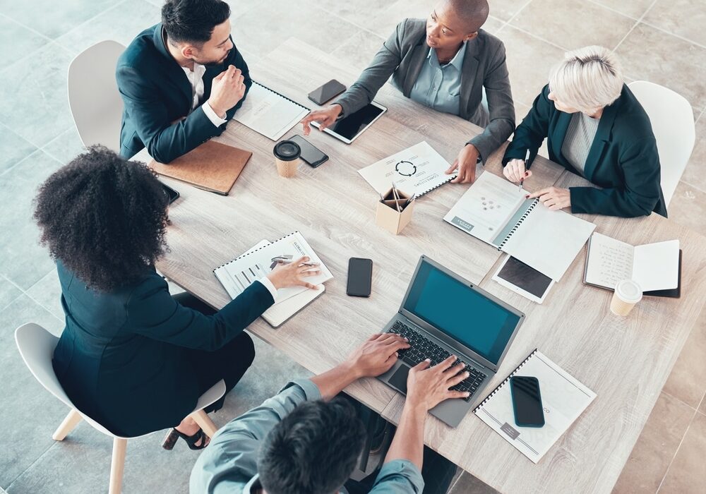 Business people discussing portfolio and company report Business people discussing portfolio and company report