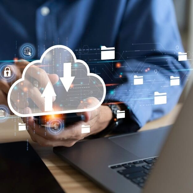 Businessman,Uses,A,Laptop,With,Technology,Cloud,Computing,For,Data Laptop with technology cloud computing for data transmission