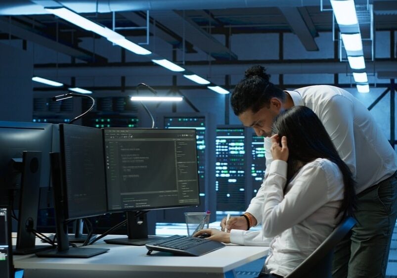 Admin in data center working with colleague to maintaining servers Admin in data center working with colleague to maintaining servers