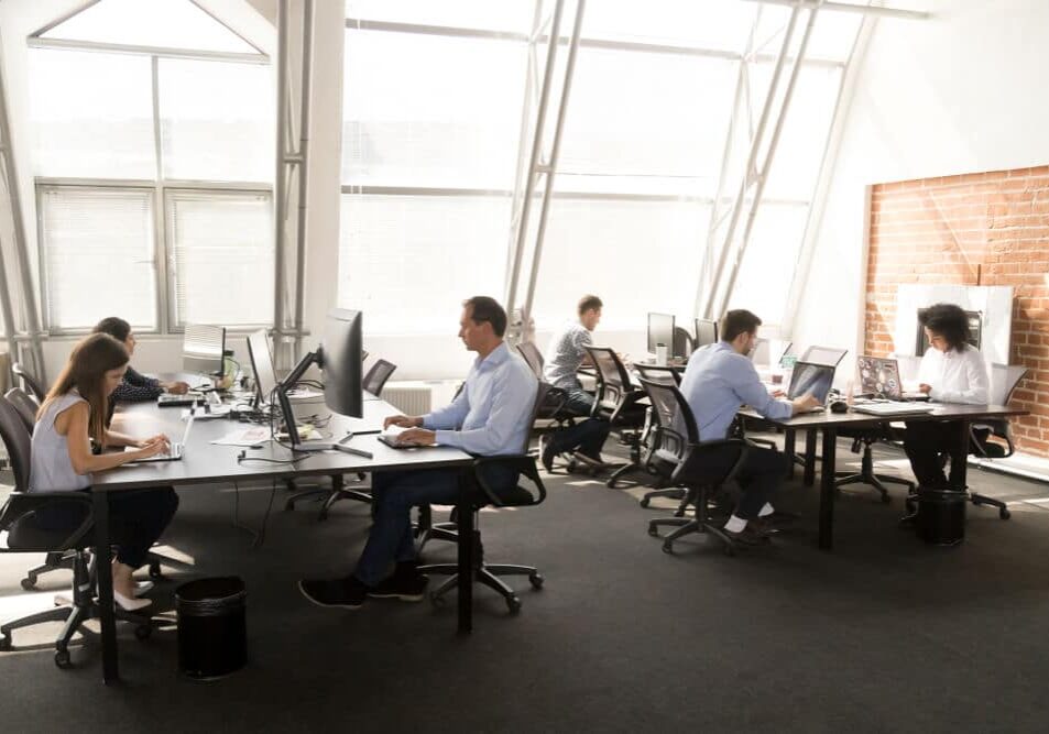 managed-it-service workers sitting at desk working in coworking space