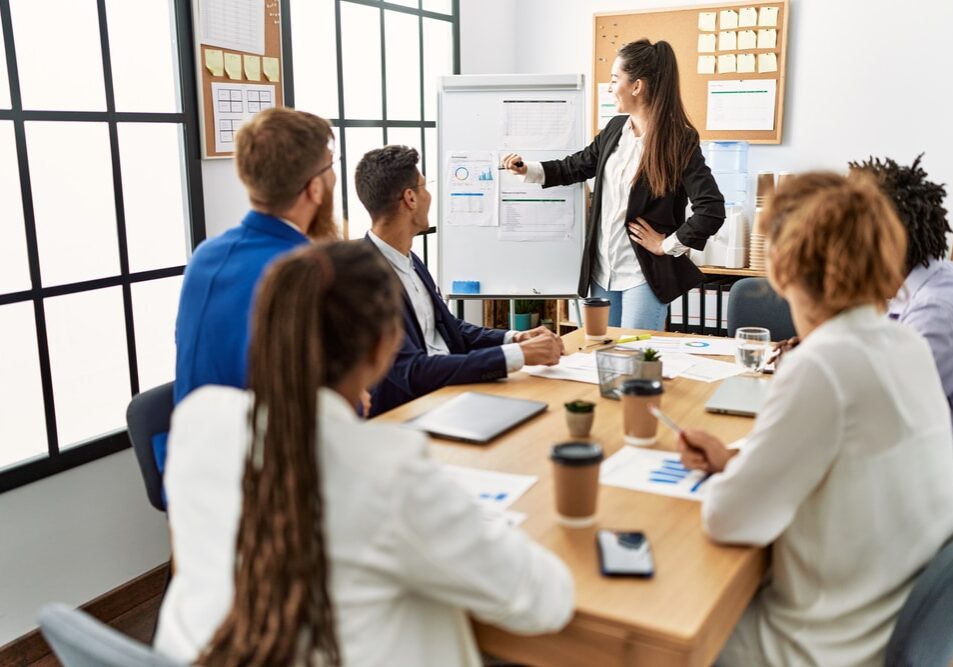 Group,Of,Business,Workers,Listening,Hispanic,Boss,Woman,Conference,At Group of business workers listening hispanic boss woman conference at the office
